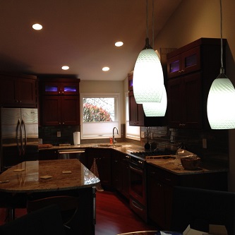 Residential kitchen electrical featuring cabinets and hanging lights